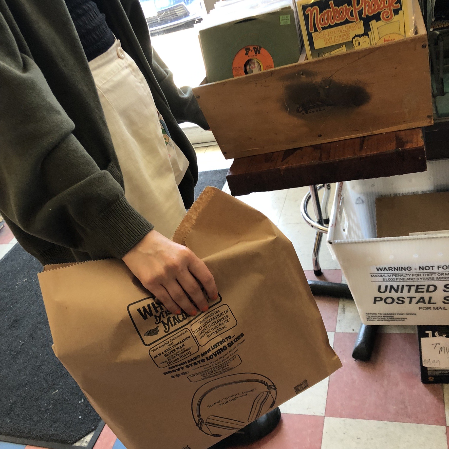 Printed kraft bag carried out of a record store